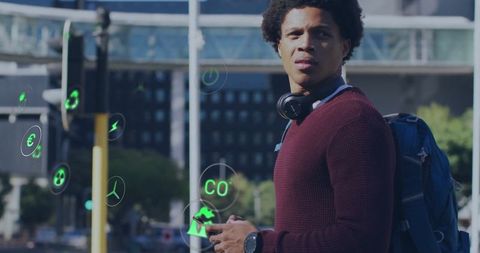 Man with headphones and backpack in urban smart city environment