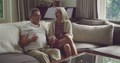 Happy Senior Couple Engaging in Lively Conversation at Home