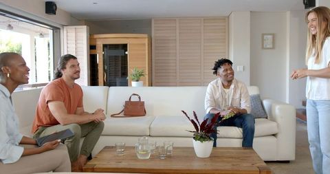 Multicultural Friends Conversing in Cozy Living Room