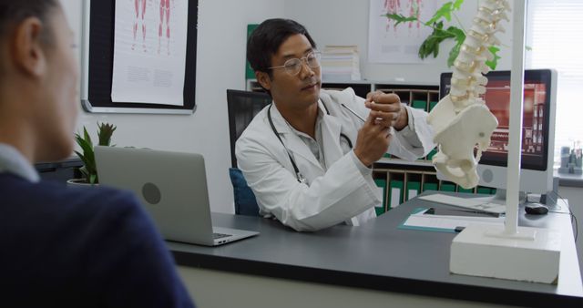 Doctor Explaining Spinal Anatomy to Patient in Medical Office - Download Free Stock Images Pikwizard.com