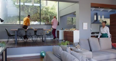 Friends preparing for birthday party in modern living room