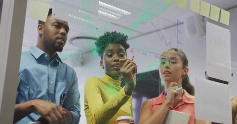 Diverse Team Collaborating in Office with Whiteboard Brainstorming