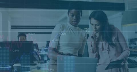 Businesswomen Analyzing Financial Data with Laptop in Modern Office