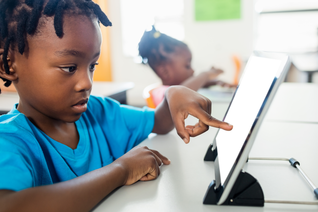 Boy Interacting with Transparent Digital Tablet in Classroom - Download Free Stock Videos Pikwizard.com