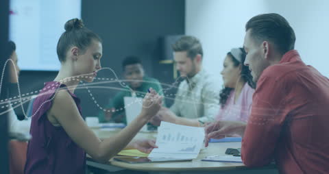 Diverse Business Team Analyzing Data Models in Modern Office