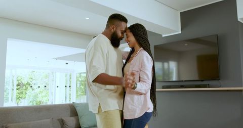 Couple Dancing and Embracing in Bright Modern Living Room