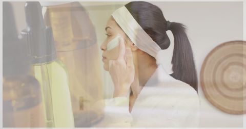 Wellbeing ritual: woman using beauty product with essential oil