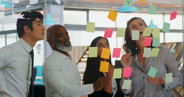 Diverse Business Team Brainstorming with Colorful Sticky Notes on Glass - Download Free Stock Images Pikwizard.com