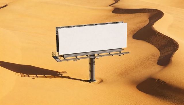 Blank billboard standing in desert dunes casting long shadow minimalist marketing mockup