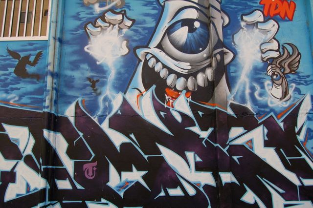 Colorful Graffiti Mural with Monstrous Figure and Abstract Designs - Download Free Stock Photos Pikwizard.com