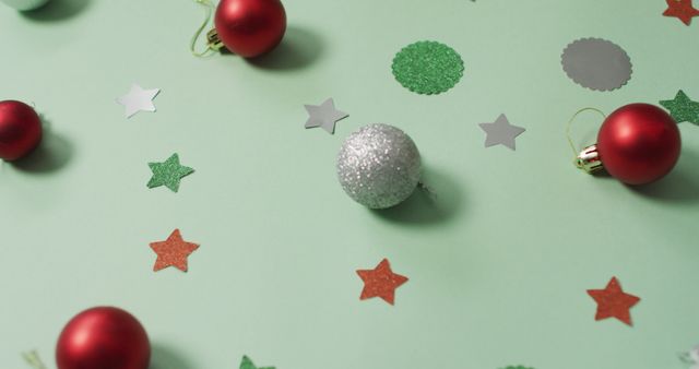 Christmas decorations with silver and red bauble on green background. christmas, tradition and celebration concept image.