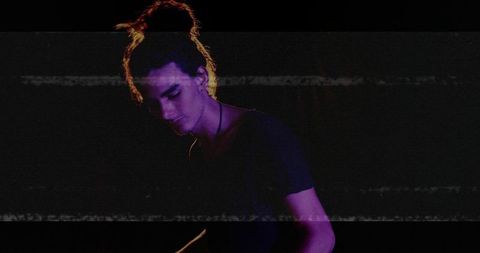 Male Performer Adjusting Audio Controls with Glitch Effects