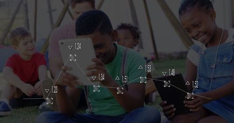 Kids and adults engaging with tablets outdoors in park playground