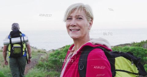 Senior couple enjoying an active hiking adventure on coastal trail
