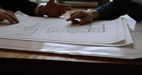 Architects Reviewing Architectural Plans During Meeting - Download Free Stock Images Pikwizard.com
