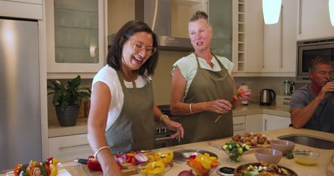 Friends cooking together in cozy modern kitchen