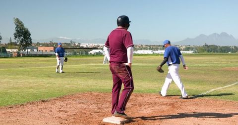 Baseball players engaged in outdoor game action