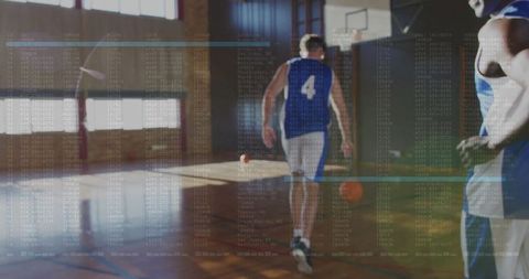 Basketball Player Walking Toward Hoop in Gym