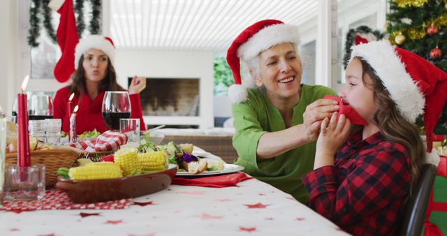 Family Celebrating Christmas Dinner at Festively Decorated Table - Download Free Stock Images Pikwizard.com