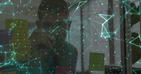 Senior Professional Reviewing Digital Network on Sticky Notes in Modern Office