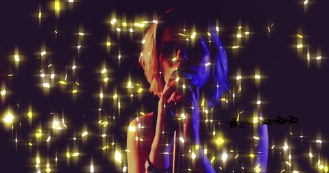 Teenage Girl Performing on Stage Amid Sparkling Lights