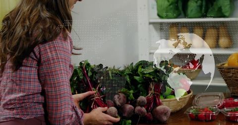 Woman Arranging Fresh Beets at Farmers Market Stall for Sustainable Produce Promotion