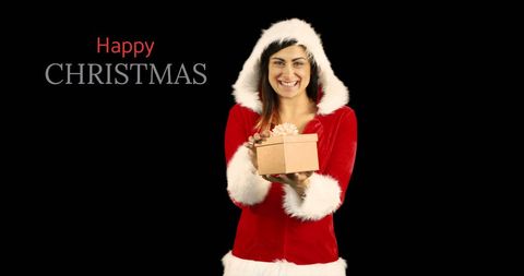 Joyful woman in santa outfit holding christmas gift