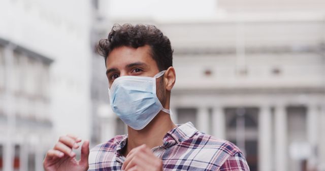 Young Man Wearing Mask Outdoors in Urban Setting - Download Free Stock Images Pikwizard.com