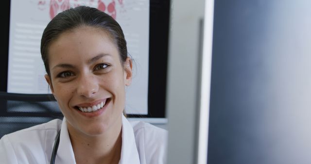 Smiling Female Doctor Working at Office Desk - Download Free Stock Images Pikwizard.com