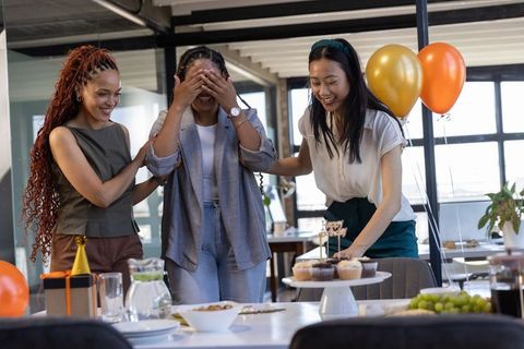 Coworkers Delivering Birthday Surprise at Modern Office Celebration