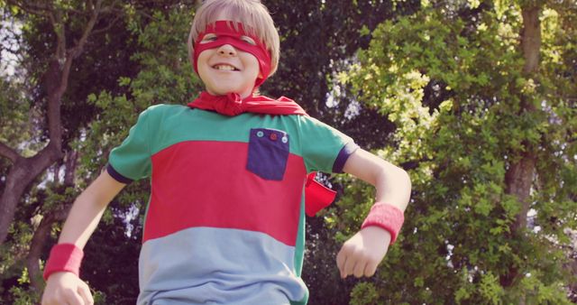 Joyful Child Pretending to Be a Superhero in Green Park - Download Free Stock Photos Pikwizard.com