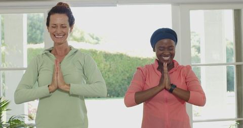 Diverse Women Practicing Yoga for Wellness and Calm Indoors