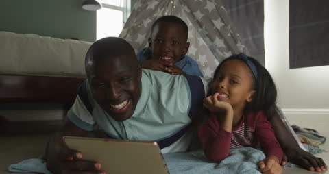Smiling African American Family Enjoying Tablet Time Together