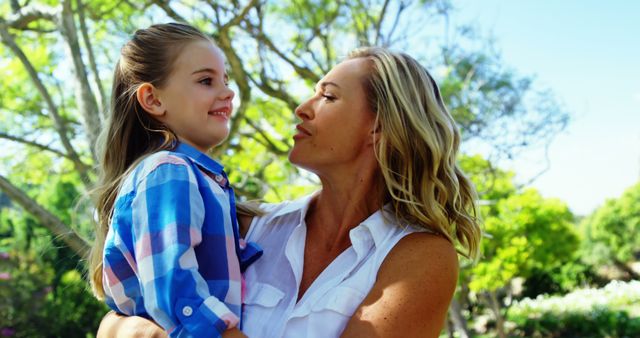 Happy Mother Holding Daughter in Sunny Park - Download Free Stock Images Pikwizard.com