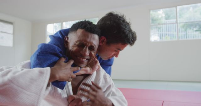 Two Men Practicing Judo Techniques on Red Mats in Studio - Download Free Stock Images Pikwizard.com