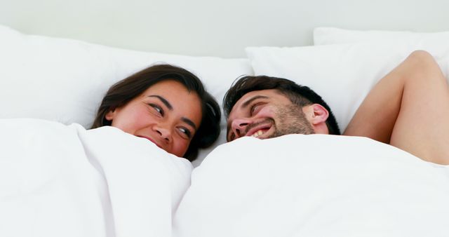 Happy Couple Relaxing and Smiling in Bed - Download Free Stock Images Pikwizard.com
