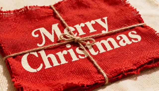 Rustic red burlap merry christmas banner tied with twine bow for holiday decor