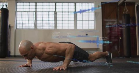 Shirtless athlete holding low push-up in industrial gym with blue performance overlays