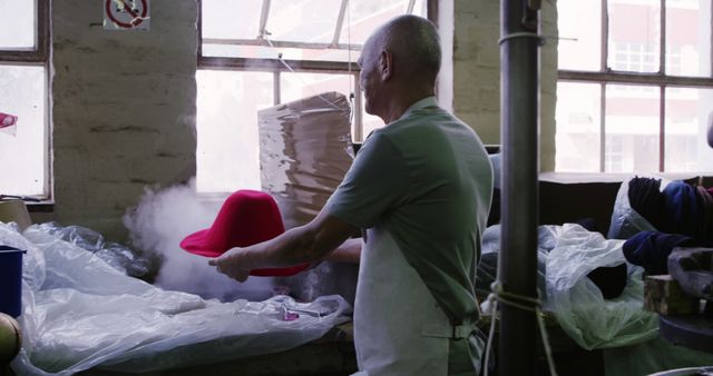 Senior Craftsman Shaping Red Hat Using Steam in Workshop - Download Free Stock Images Pikwizard.com