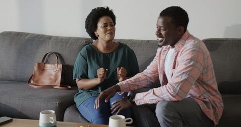 Friends Enjoying Coffee and Conversation in Cozy Living Room
