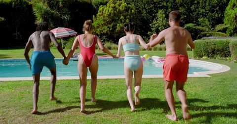Group of Friends Holding Hands by Backyard Pool in Summer Fun Mode
