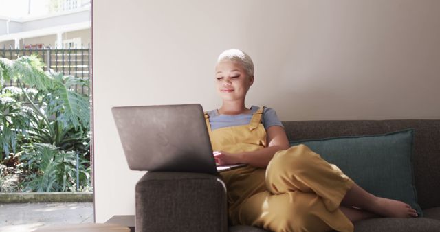 Woman Relaxing on Couch with Laptop in Sunlit Home - Download Free Stock Images Pikwizard.com