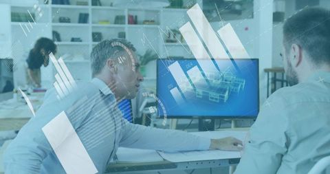 Engineers collaborating over CAD model on widescreen monitor in open-plan office