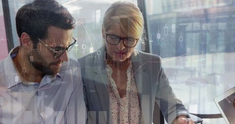 Colleagues Analyzing Data in Modern Office with Stock Market Projections