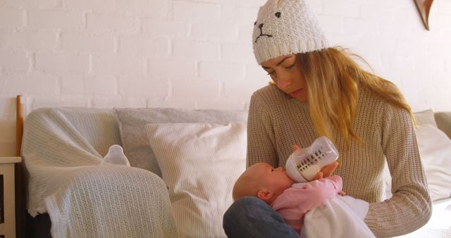 Mother Bottle Feeding Baby Girl in Cozy Living Room - Download Free Stock Images Pikwizard.com