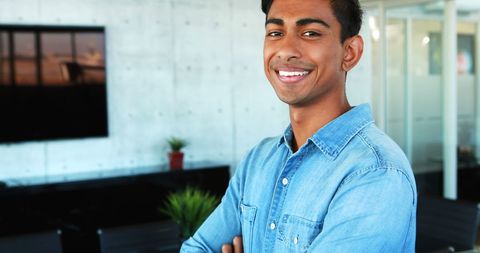Confident young executive smiling in modern office setting