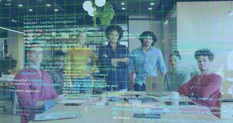Seven-person tech team reviewing projected code in open-plan workspace