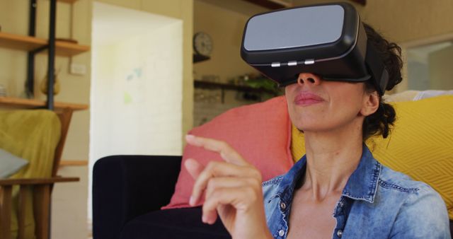 Woman interacting through virtual reality headset in an outdoor patio setting. Suitable for illustrating modern technology usage, VR experiences, and innovative ways to explore digital worlds. Great for tech blogs, VR product showcases, or articles about advancements in immersive technology.