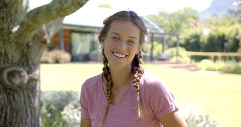 Young Woman Enjoying Outdoor Sunshine with Braided Hairstyle