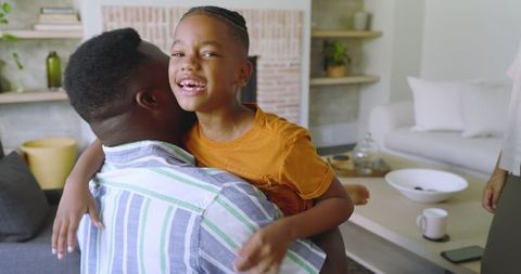 Joyful Father and Son Embrace in Cozy Living Room